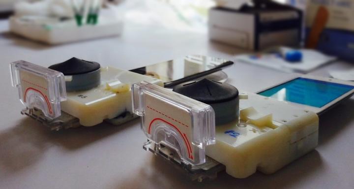 Blood Test: Smartphone dongles performed a point-of-care HIV and syphilis test in Rwanda from finger prick whole blood in 15 minutes, operated by health care workers trained on a software app. (Samiksha Nayak, Columbia Engineering)