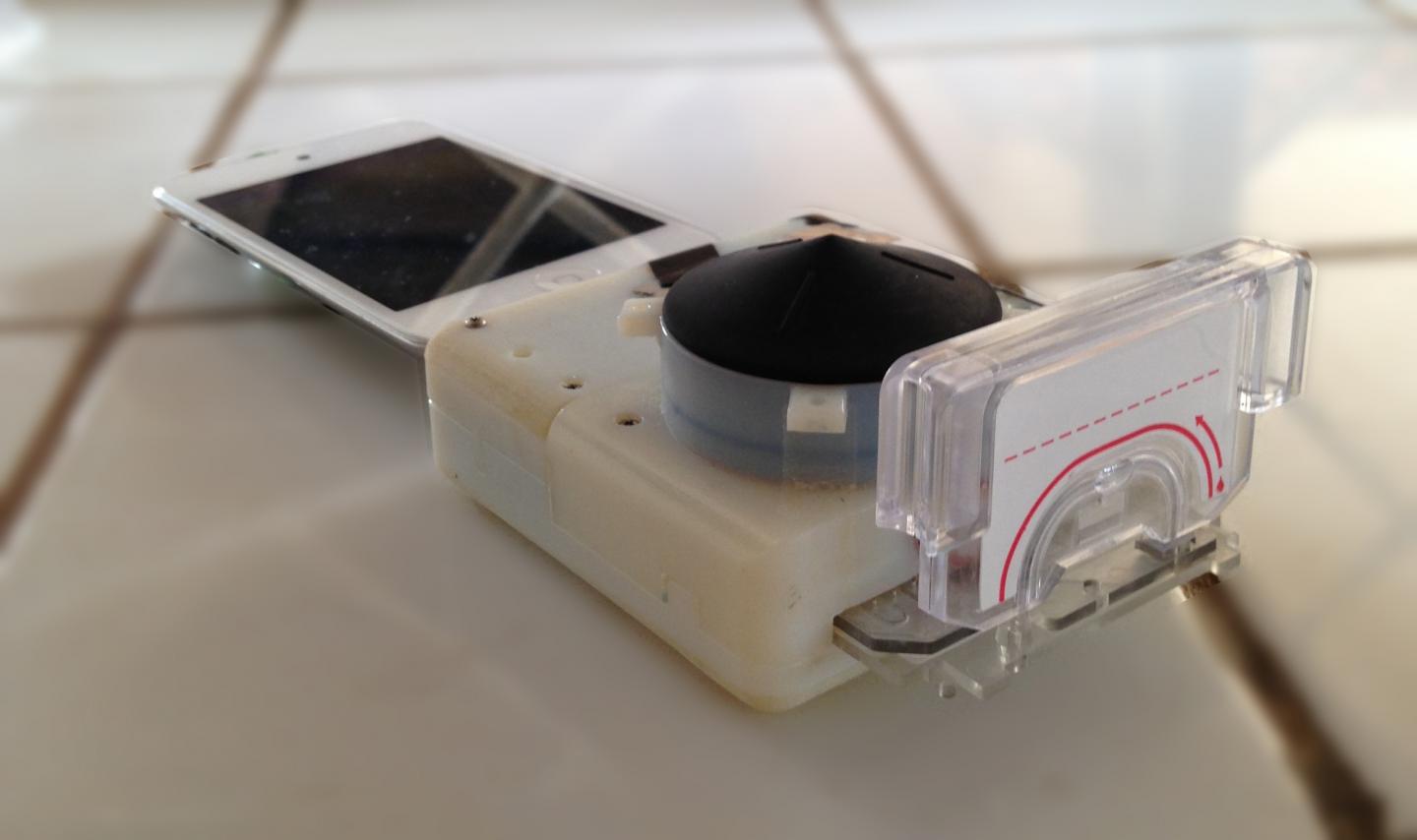The smartphone dongle uses disposable plastic cassettes for a quick and easy blood test. (Tassaneewan Laksanasopin, Columbia Engineering)