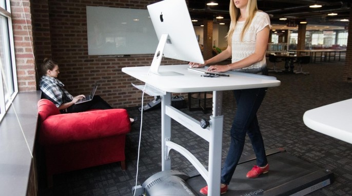 An employee working at a treadmill desk. (Jaren Wilkey/BYU)