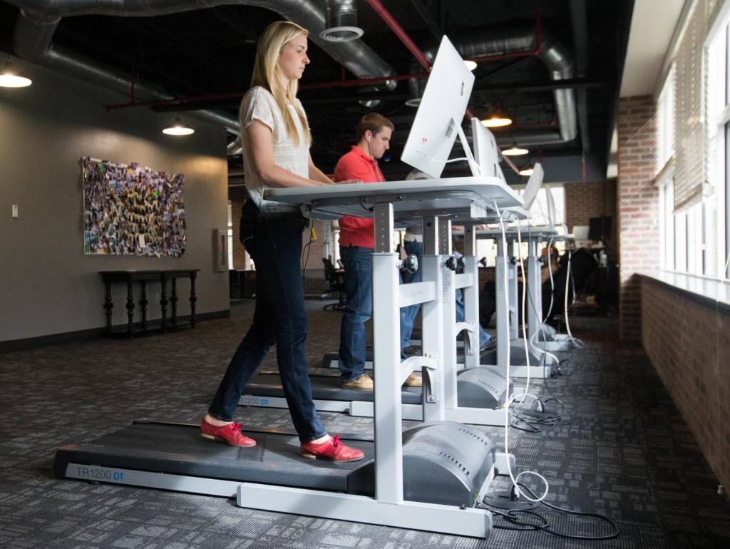 Employees work on treadmill desks at a local company. (Jaren Wilkey/BYU)