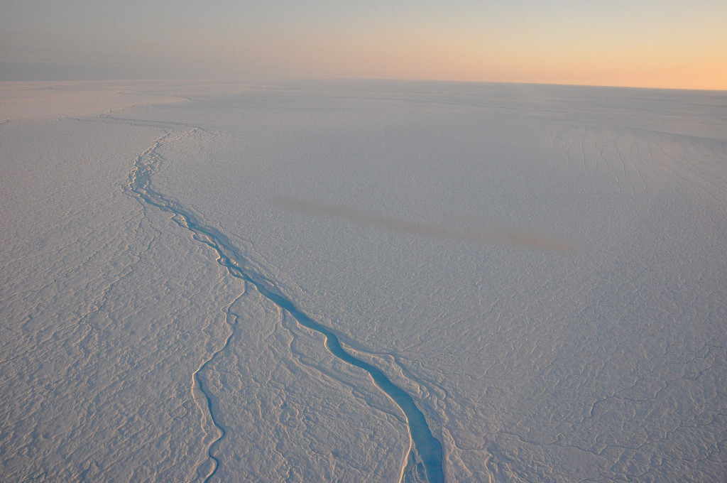 Meltwater rivers gushing on top of the ice layers in Greenland