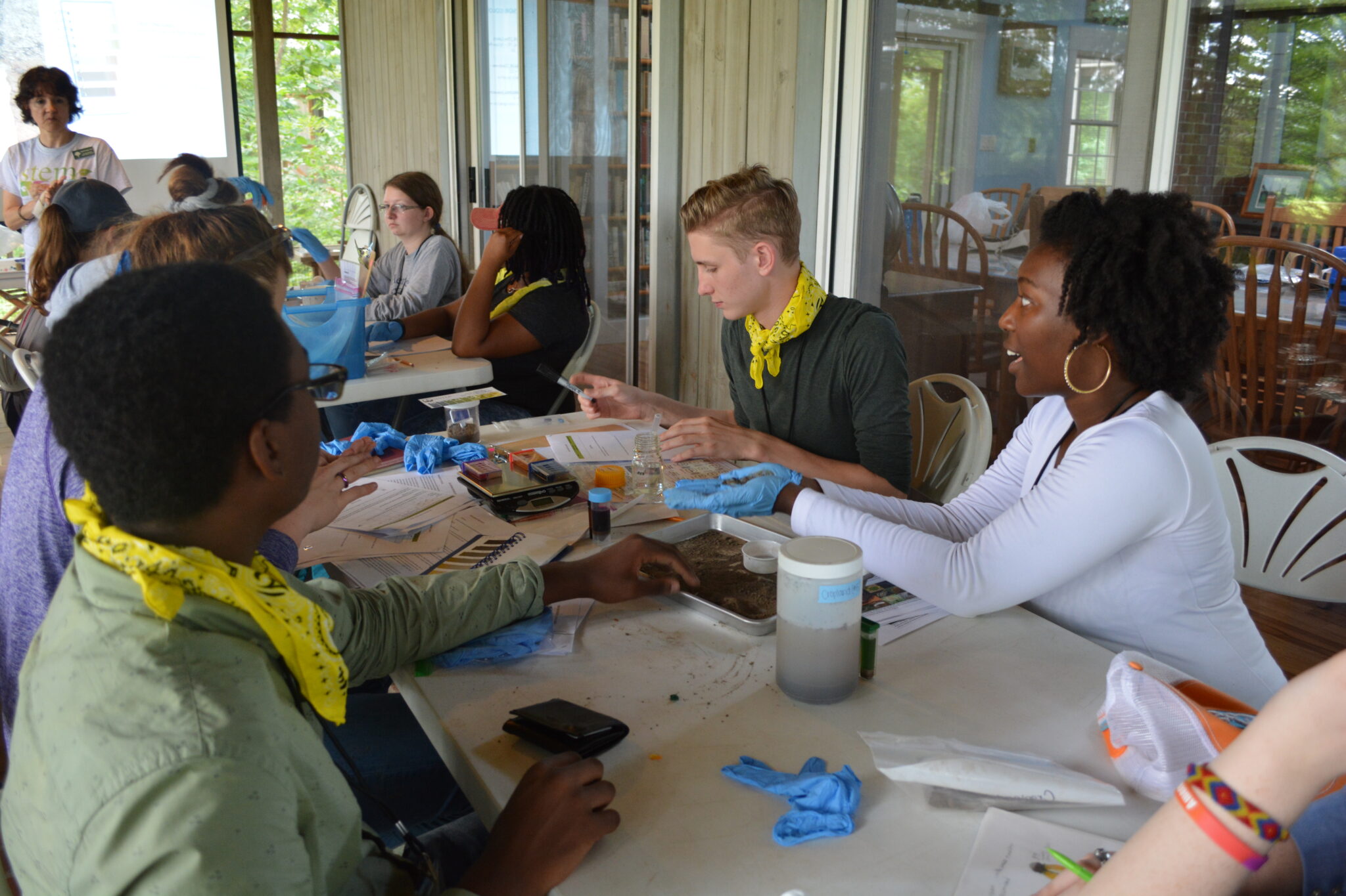 A group of volunteers holding and measuring dirt collected by the MO Dirt program.