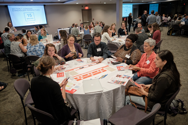 Figure Three: Forum participants and a facilitator beginning the forum deliberation. Image Credit: Museum of Science, Boston