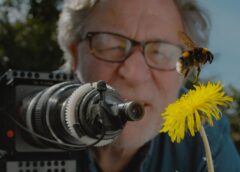 Martin Dohrn filming a bumble bee hovering over a dandelion. (Image credit: Martin Dohrn/Passion Planet)