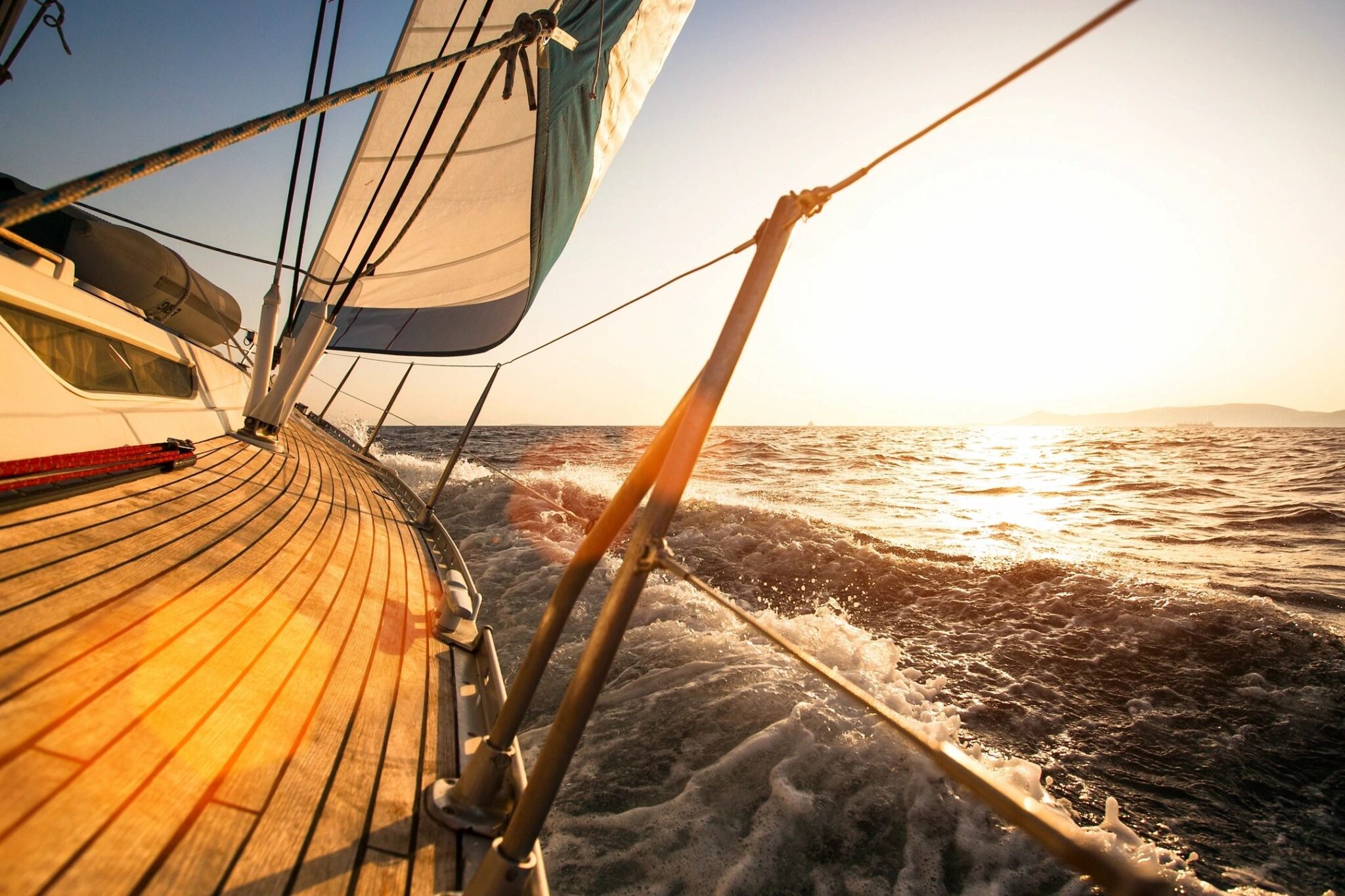 Sailboat in motion on a sun-soaked body of water