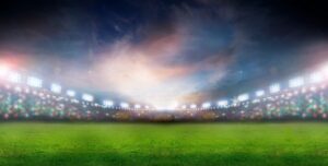 a football field flooded with bright lights and a blurry swirl of white light in center