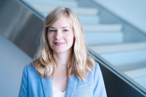 Tanja Eisemann author photo of a white woman with blonde shoulder-length hair wearing a light blue blazer