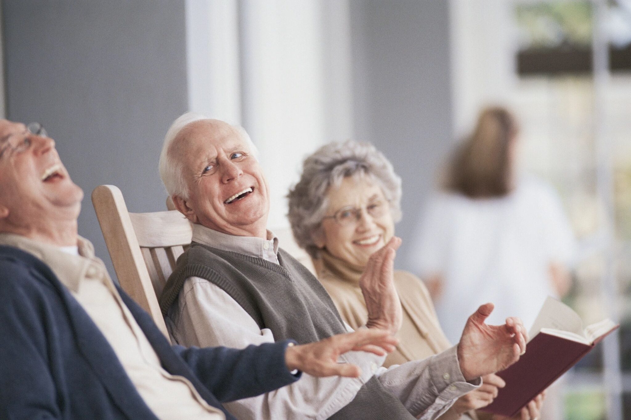 Three people older than 65 laughing together, which is a social interaction that would support brain health