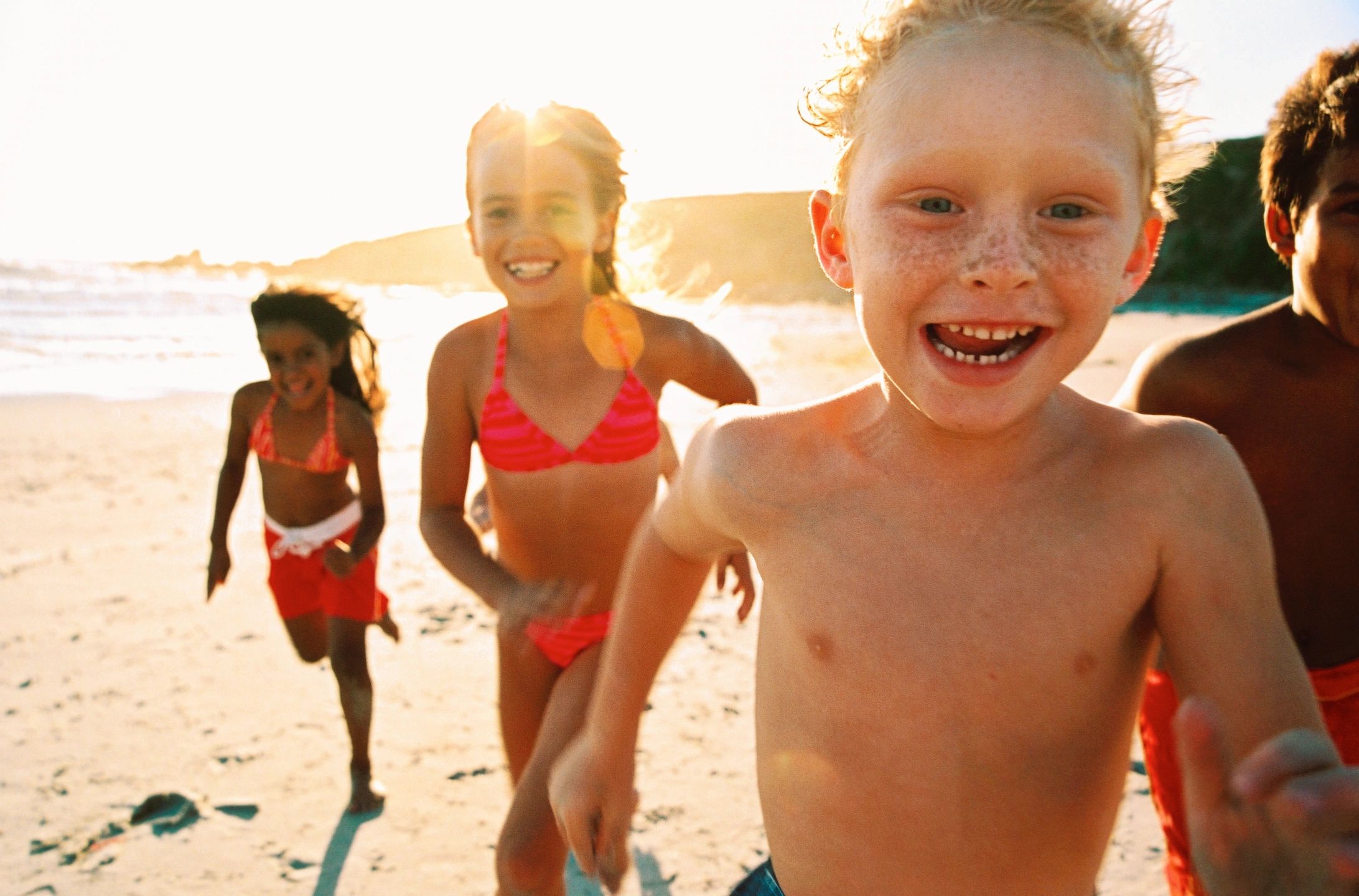 physical activity and children: a group of children run on the beach